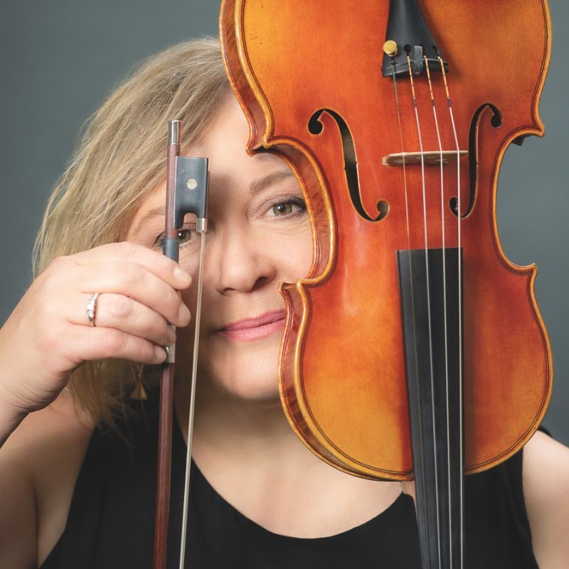 Belinda McFarlane, holding her violin and bow