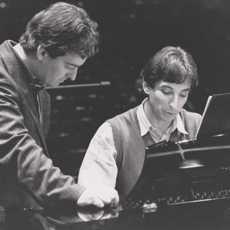 An archive photo of Lennox MacKenzie and Michael Tilson Thomas looking at a score at a piano